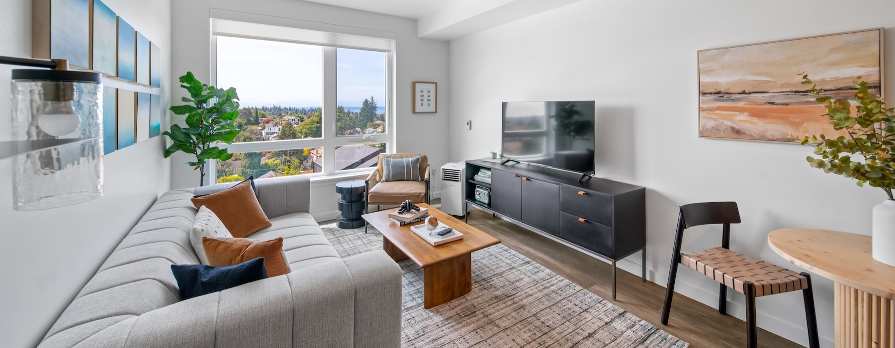 a living room with a couch, a tv and tables
