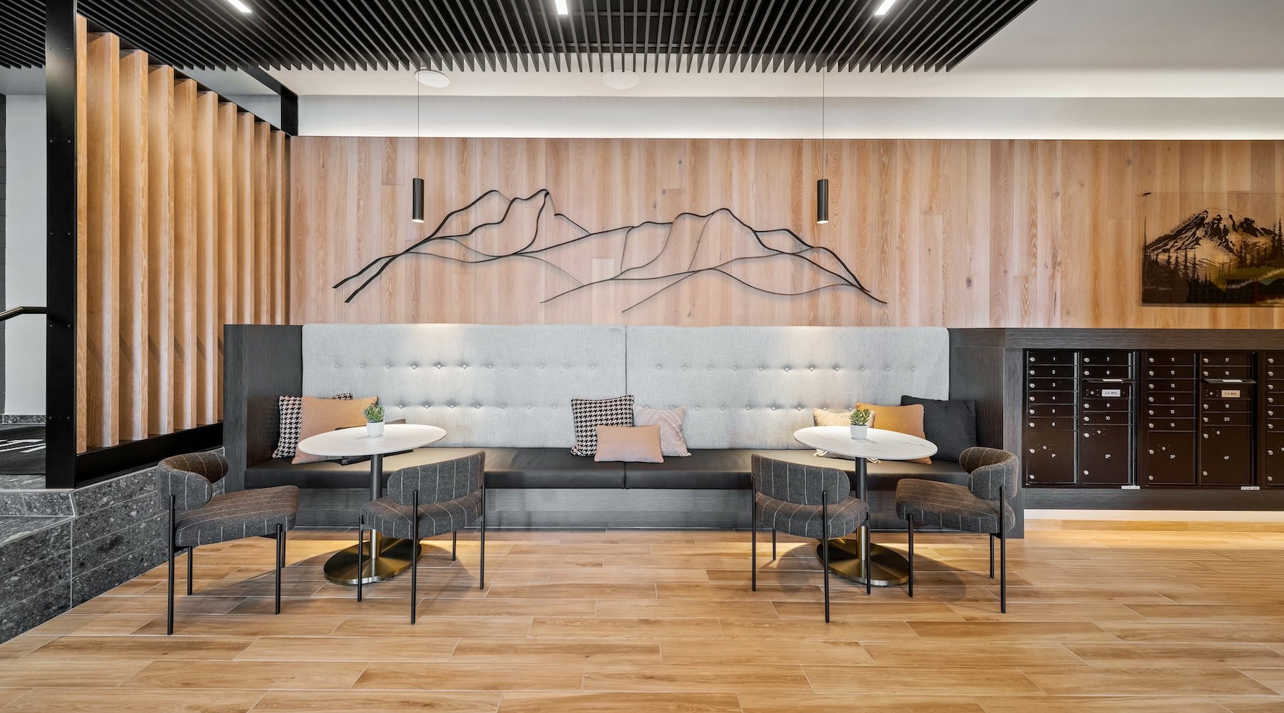 a mail room area with a booth, tables and chairs